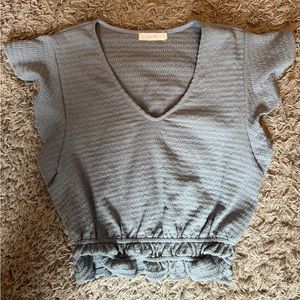 Lush light blue shirt, slightly cropped, and shorter sleeves (size medium)